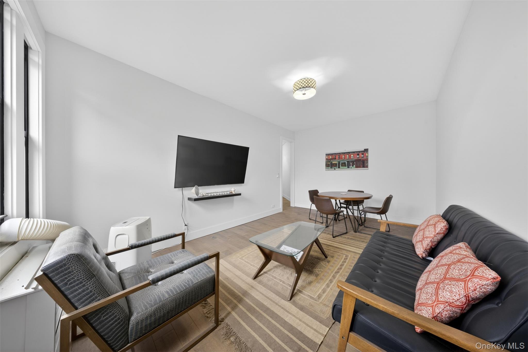 812 Riverside Drive, Unit 42 Manhattan, NY 10032 - Photo 8 of 19 a living room with furniture and a flat screen tv