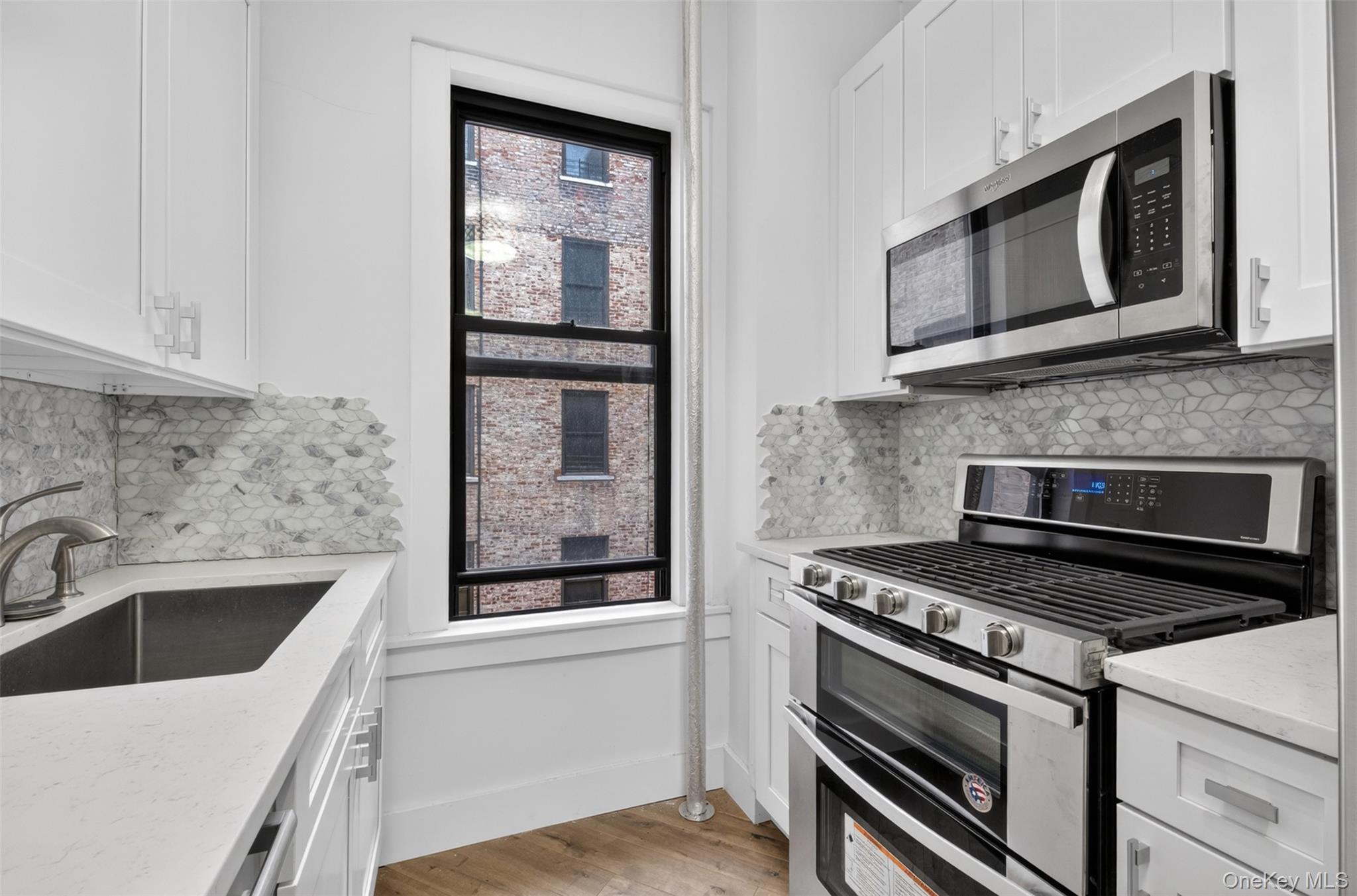 812 Riverside Drive, Unit 42 Manhattan, NY 10032 - Photo 9 of 19 a kitchen with granite countertop a stove and a sink