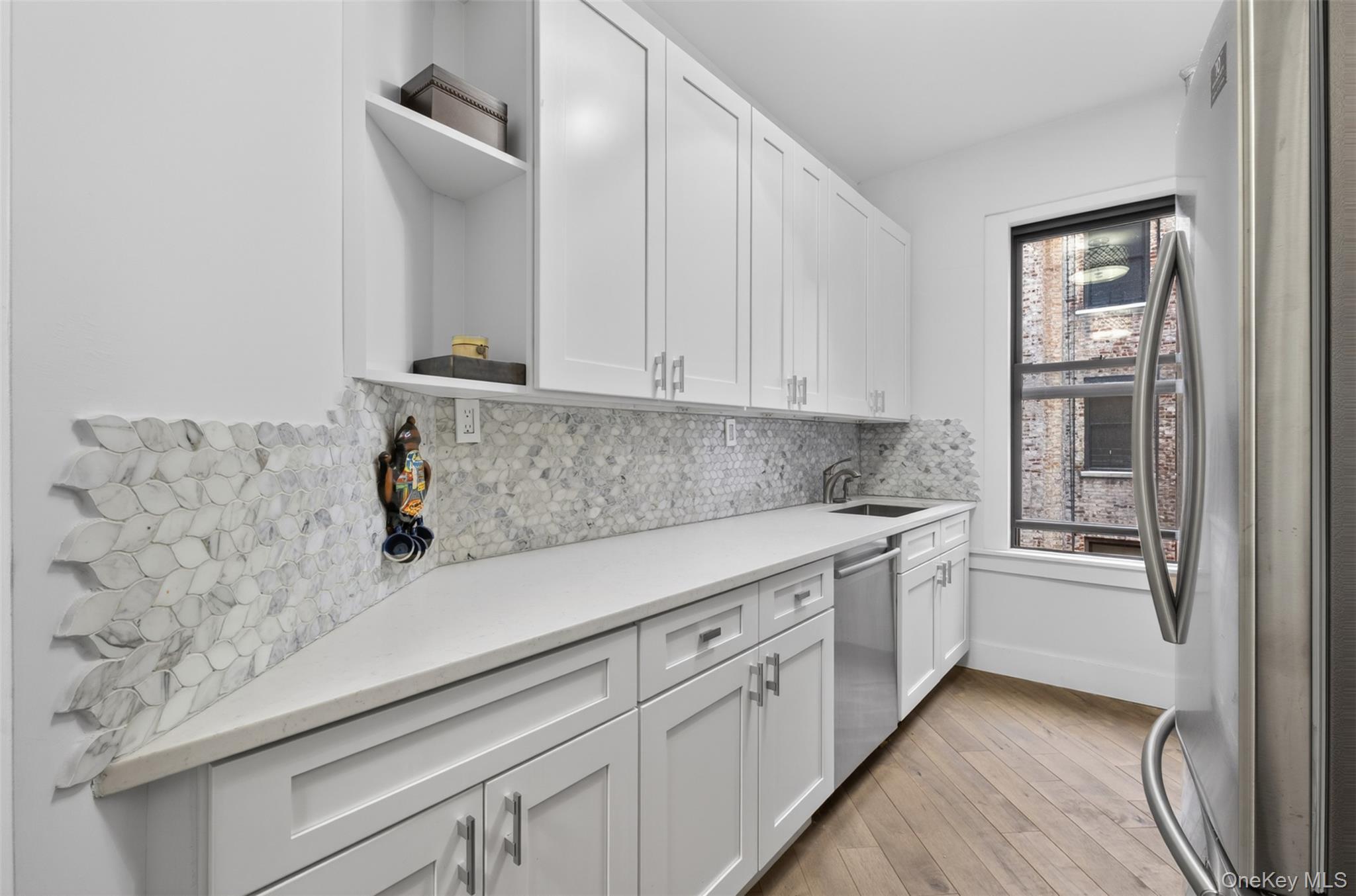 812 Riverside Drive, Unit 42 Manhattan, NY 10032 - Photo 10 of 19 a kitchen with stainless steel appliances granite countertop a sink and a stove