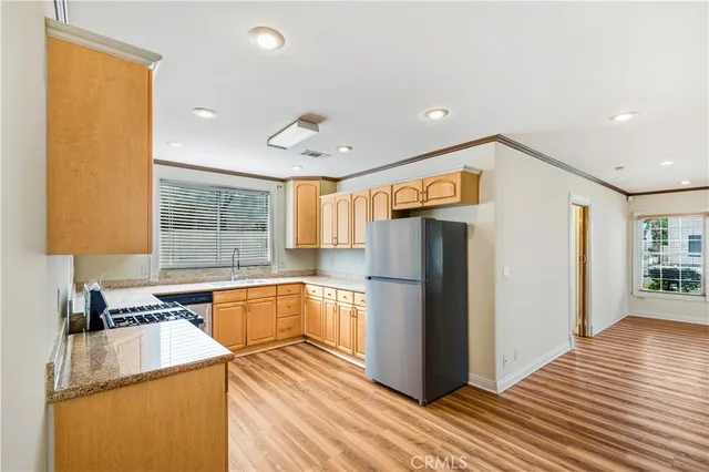 a kitchen with a refrigerator and a sink