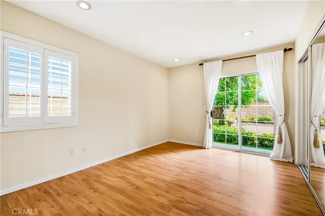 a view of a room with wooden floor and a window