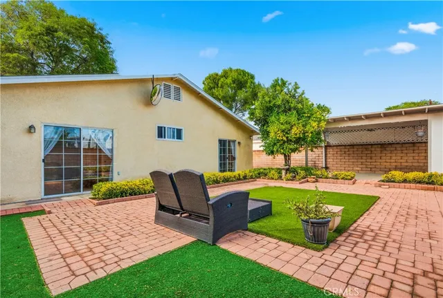 a view of a house with swimming pool and sitting area