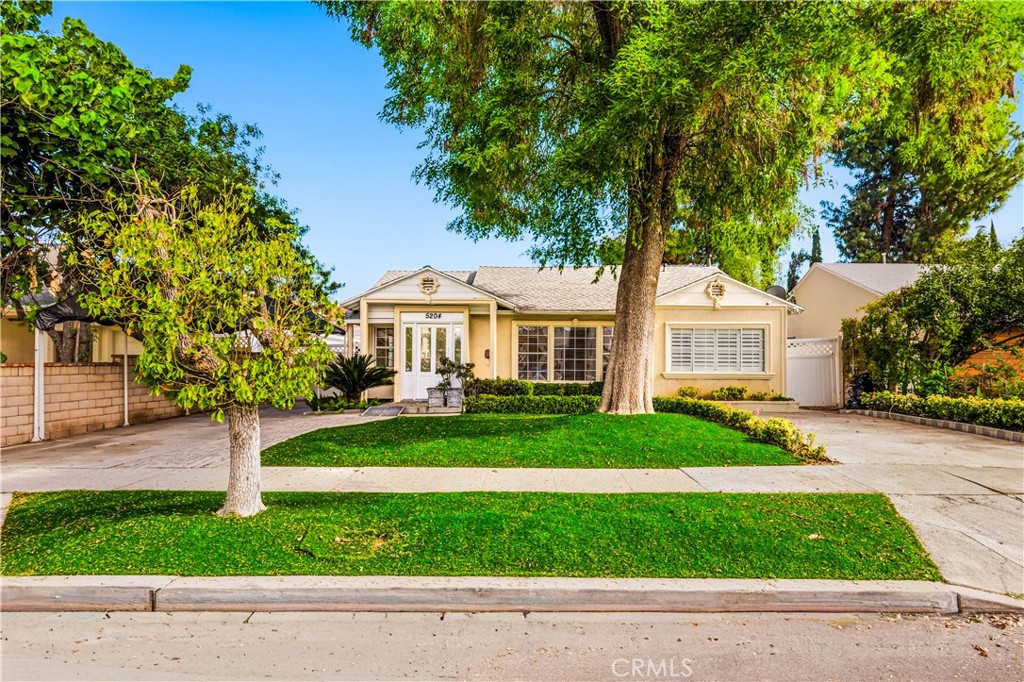 5204 Etiwanda Avenue Tarzana, CA 91356 - Photo 2 of 23 a front view of a house with a yard and porch