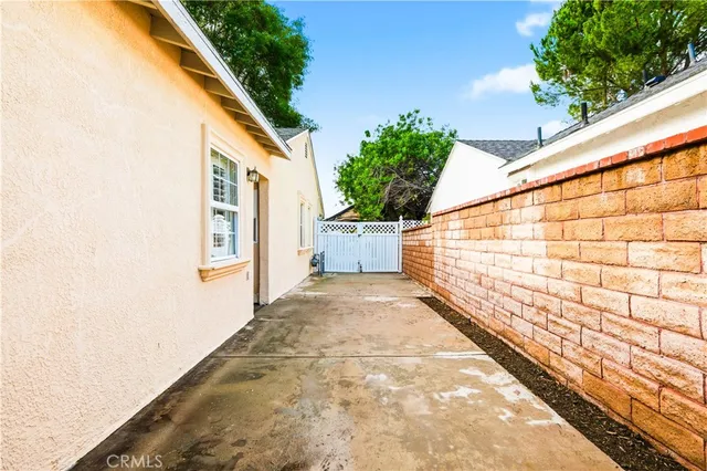 a view of a pathway with a house on the background