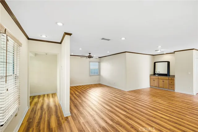 a view of empty room with wooden floor