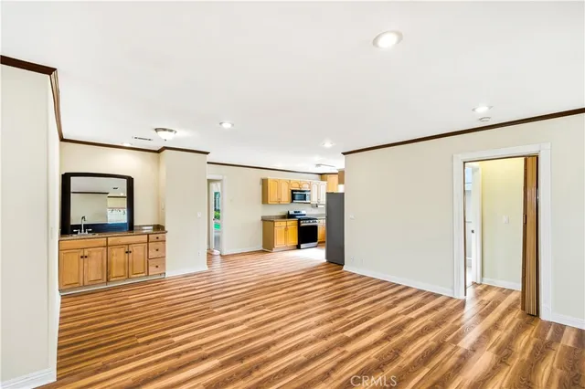 a view of a kitchen with a sink and a refrigerator