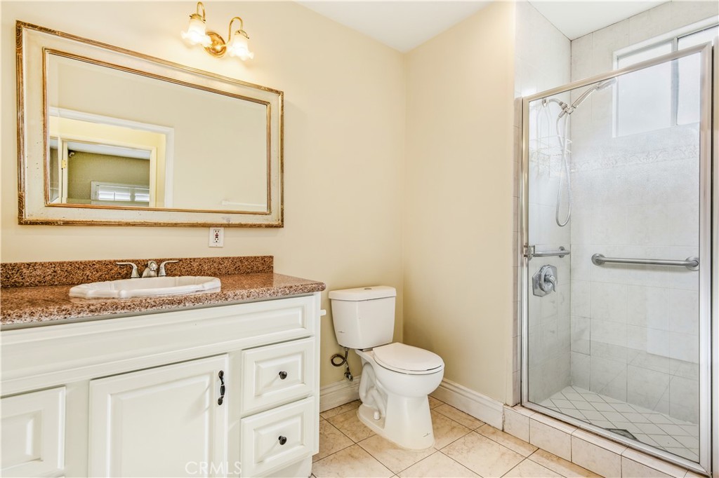 5204 Etiwanda Avenue Tarzana, CA 91356 - Photo 9 of 23 a bathroom with a granite countertop sink toilet and shower