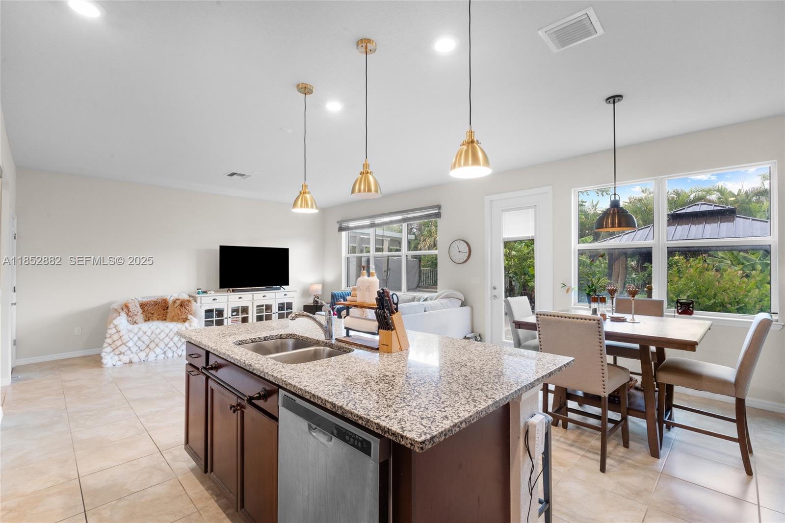 4248 Ficus Street Hollywood, FL 33021 - Photo 14 of 69 a view of a dining room and livingroom with furniture wooden floor a chandelier