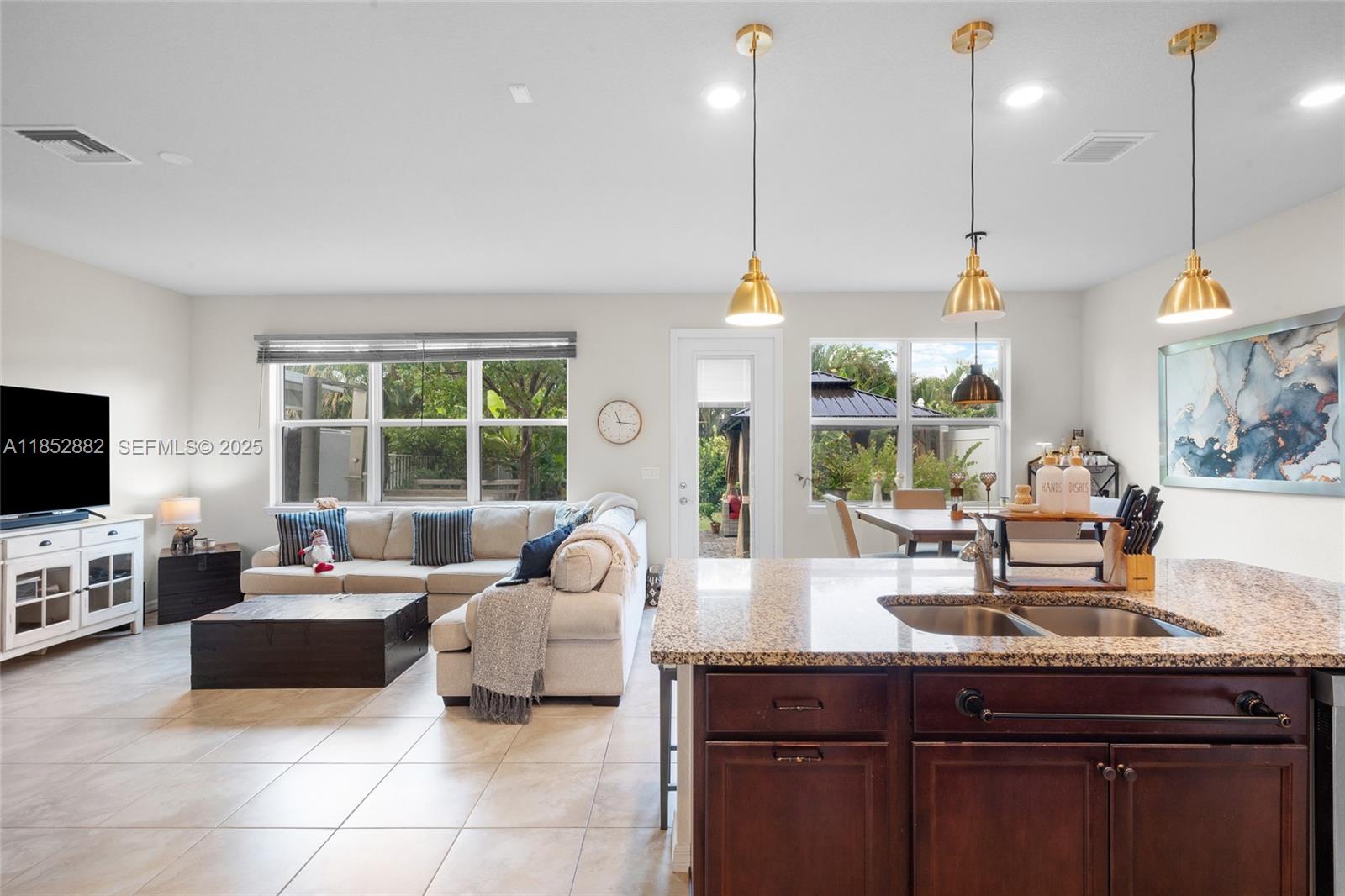4248 Ficus Street Hollywood, FL 33021 - Photo 20 of 69 a living room with furniture a flat screen tv and a large window