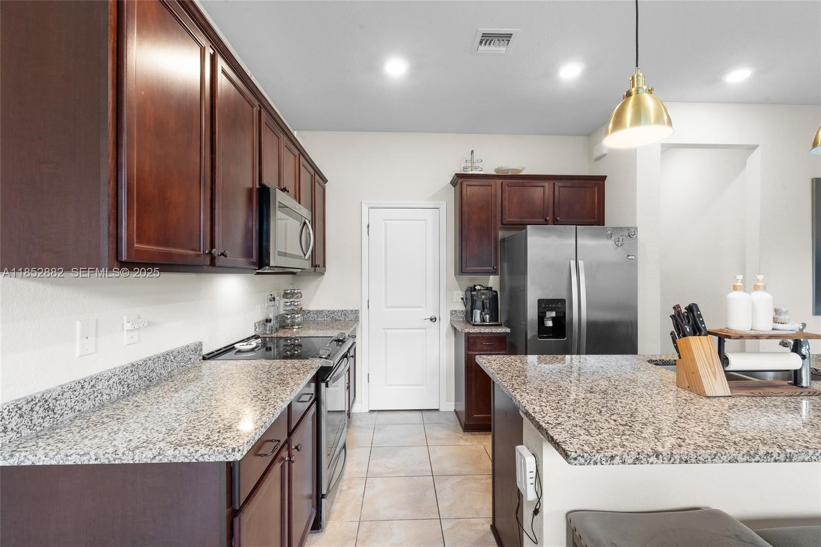 4248 Ficus Street Hollywood, FL 33021 - Photo 21 of 69 a kitchen with stainless steel appliances granite countertop a sink stove and refrigerator