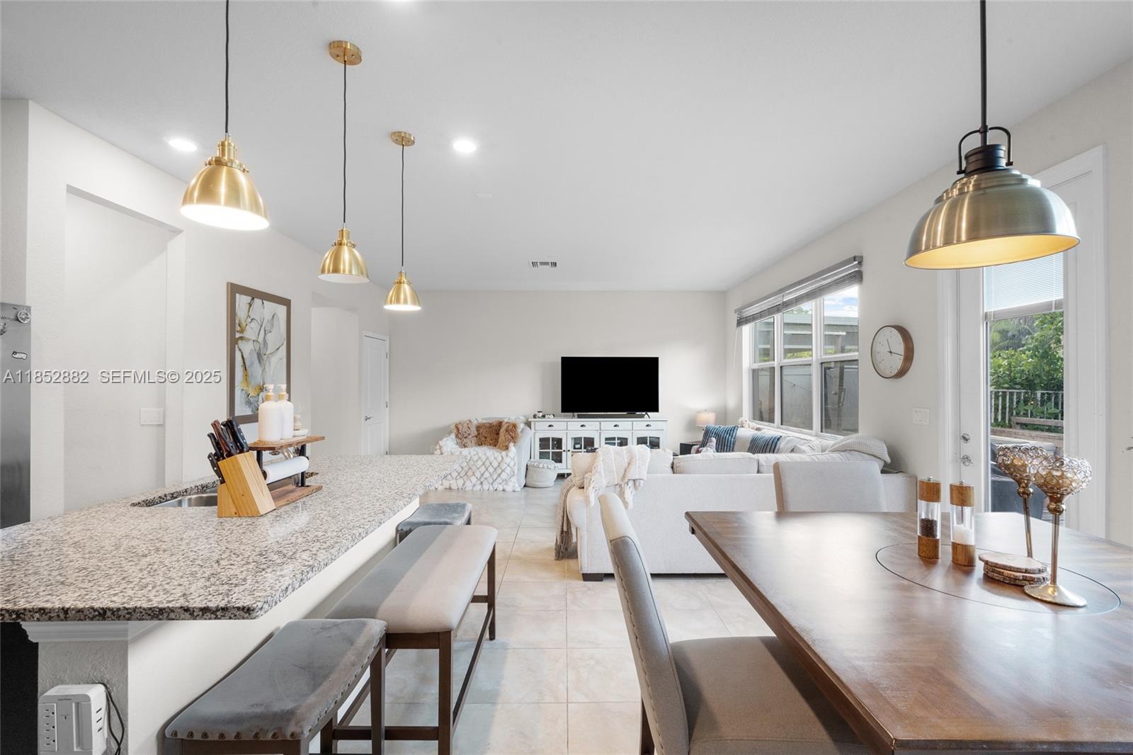 4248 Ficus Street Hollywood, FL 33021 - Photo 22 of 69 a living room with furniture a flat screen tv and a large window
