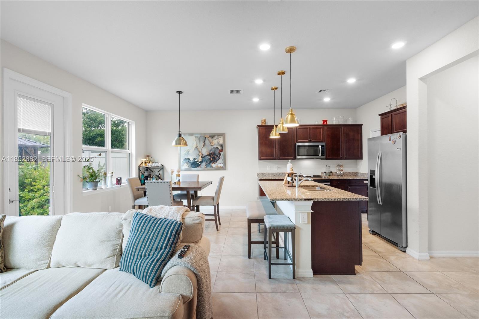 4248 Ficus Street Hollywood, FL 33021 - Photo 24 of 69 a living room with stainless steel appliances kitchen island granite countertop a couch and a view of living room