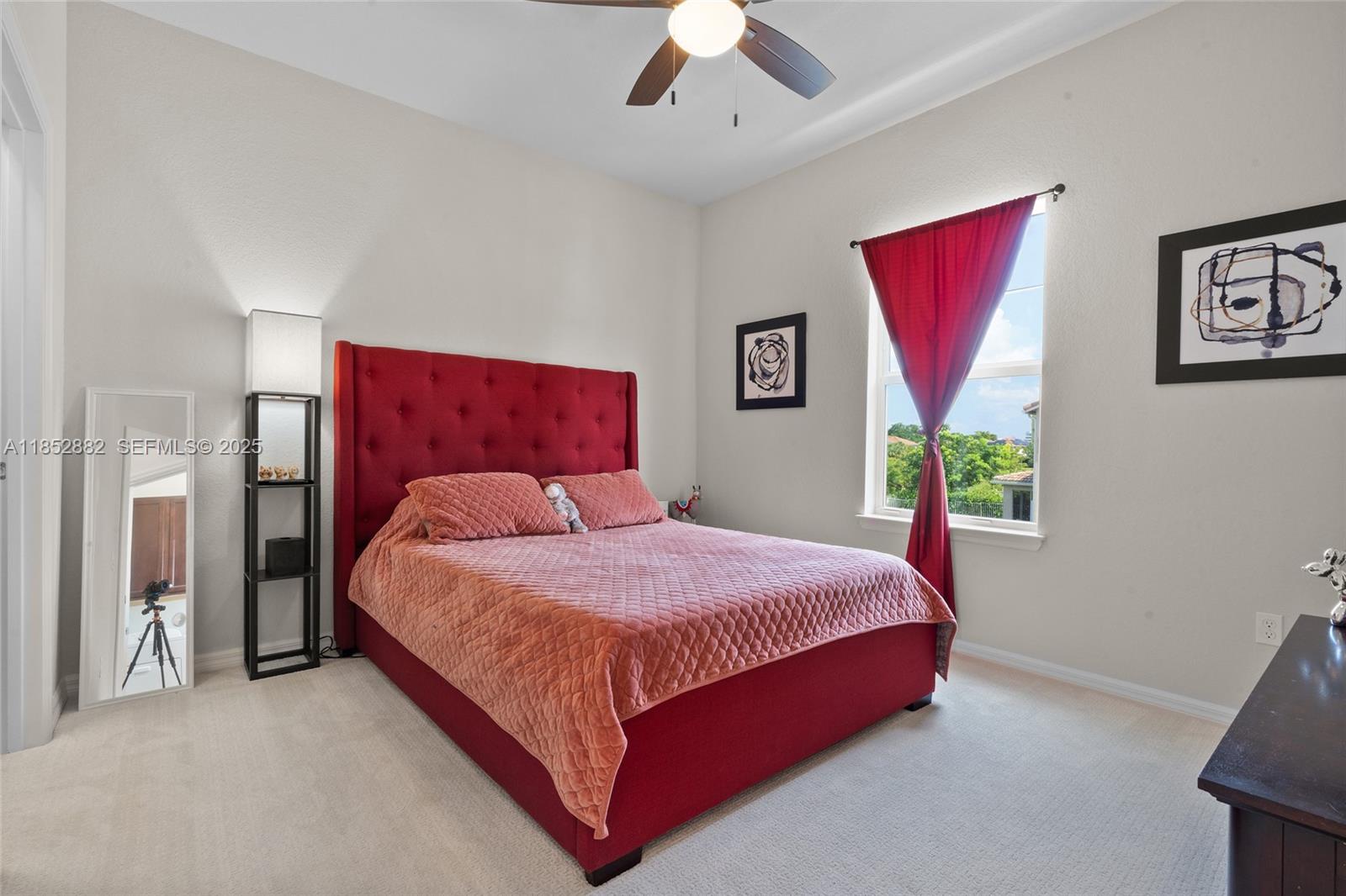 4248 Ficus Street Hollywood, FL 33021 - Photo 28 of 69 a bedroom with a bed a bookshelf and a painting