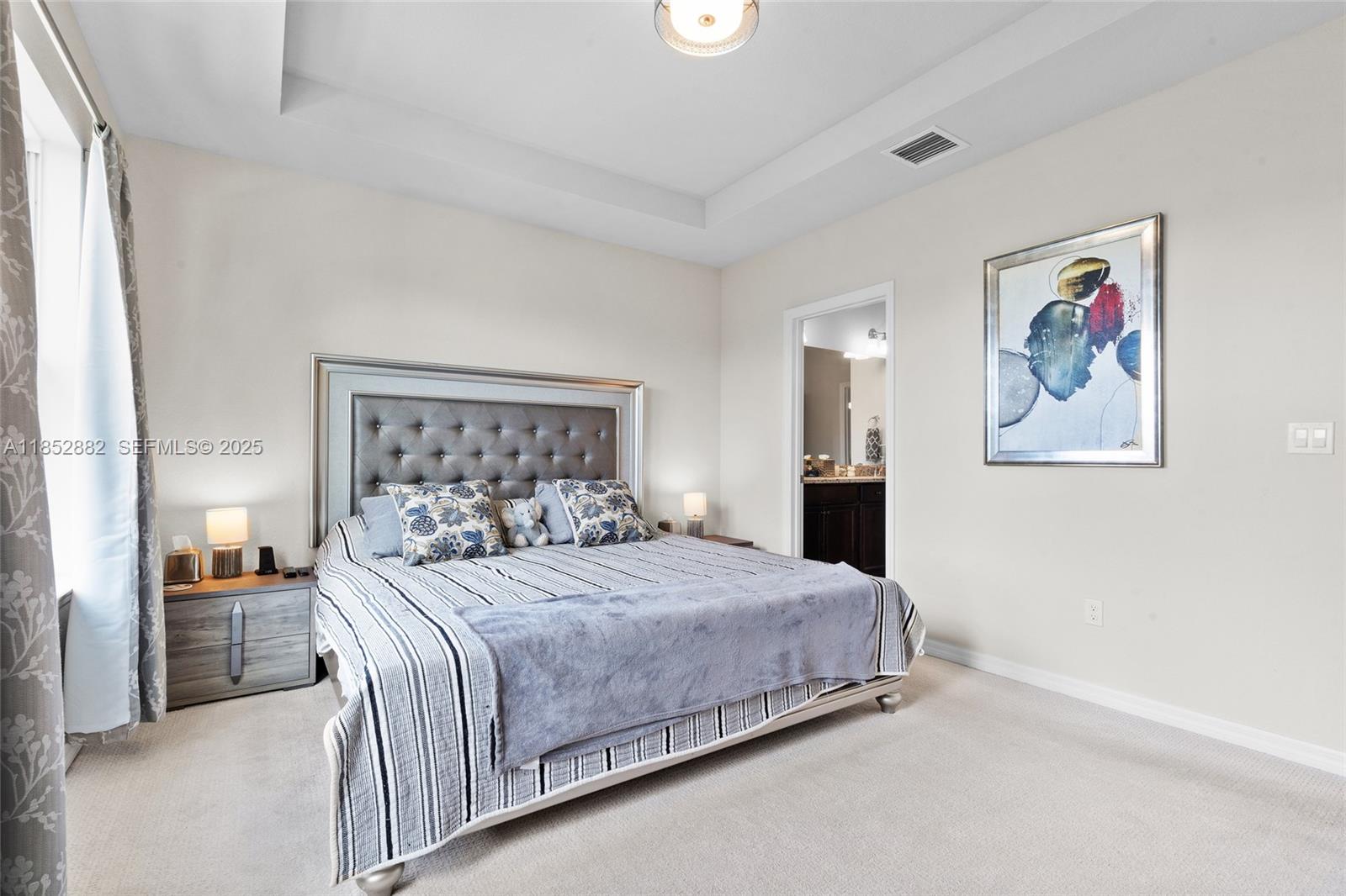 4248 Ficus Street Hollywood, FL 33021 - Photo 33 of 69 a bedroom with a large bed and a chandelier