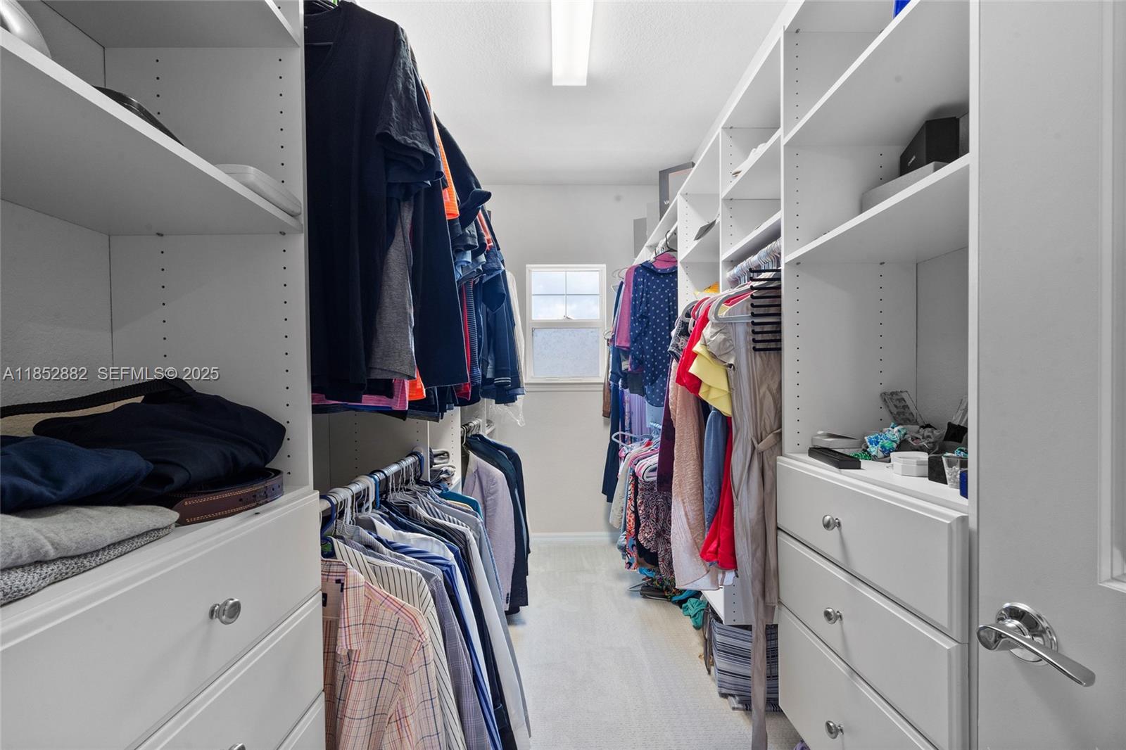 4248 Ficus Street Hollywood, FL 33021 - Photo 35 of 69 a view of walk in closet with clothes and shoes