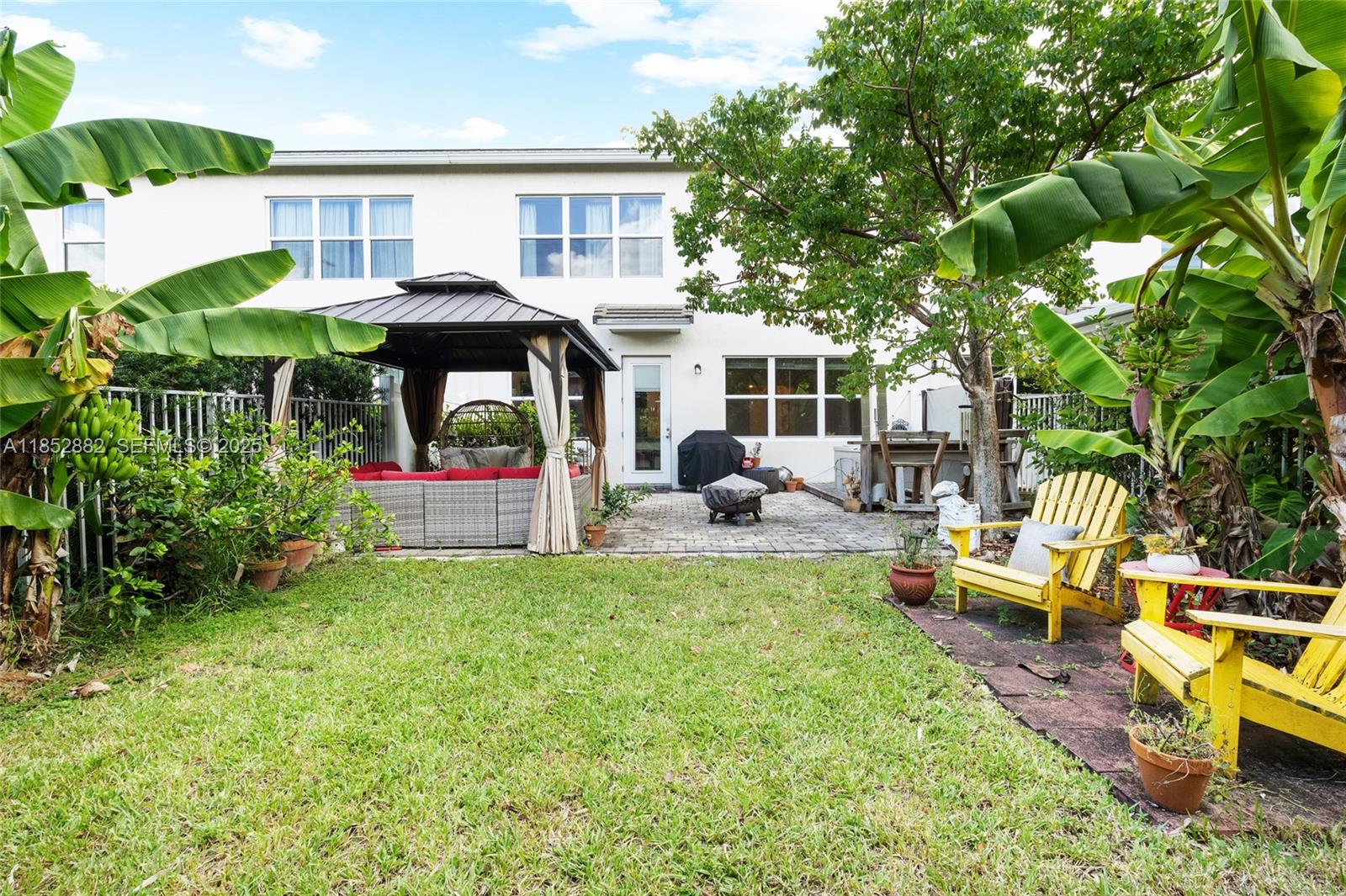 4248 Ficus Street Hollywood, FL 33021 - Photo 44 of 69 a view of a house with backyard sitting area and garden