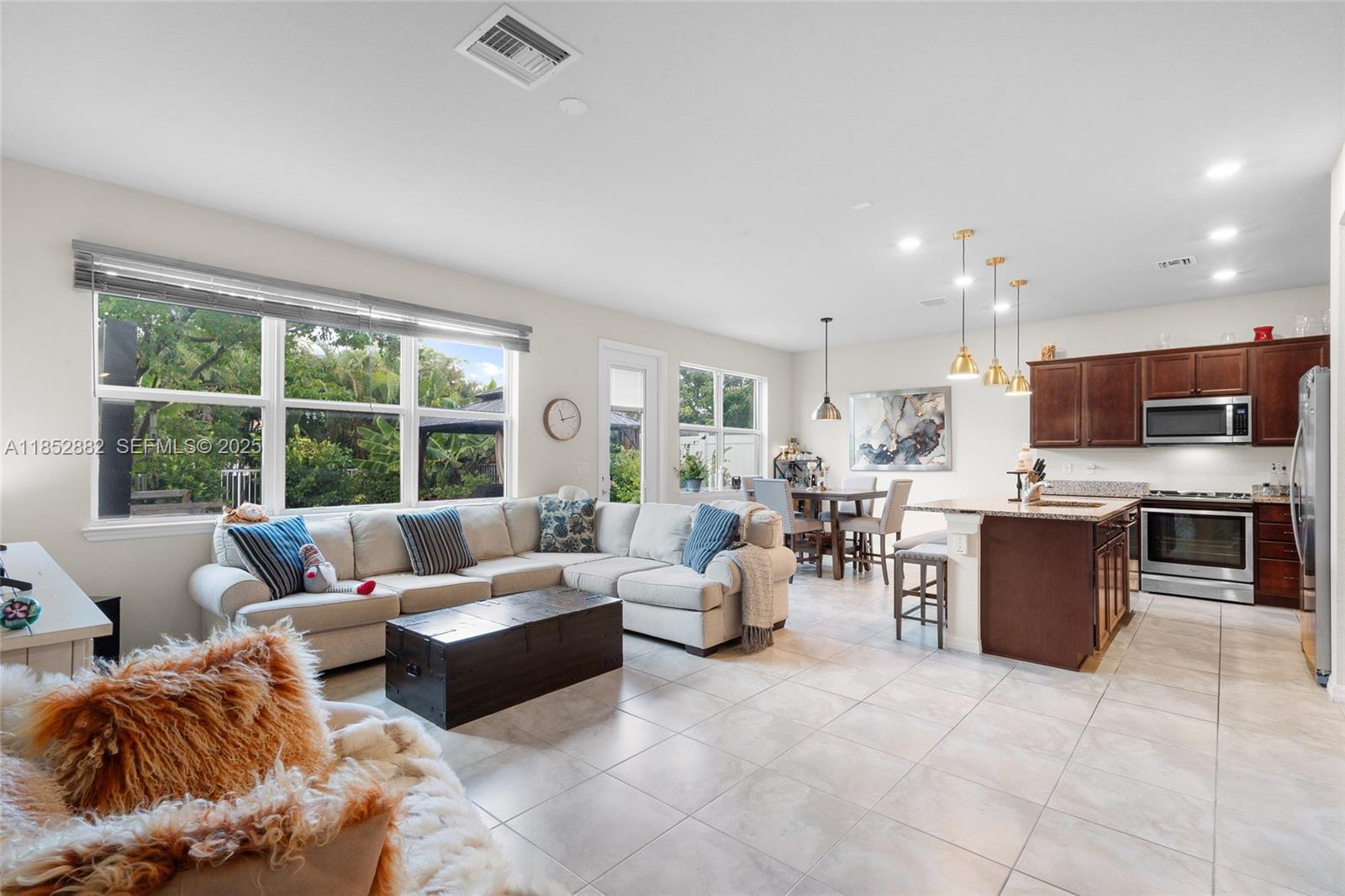 4248 Ficus Street Hollywood, FL 33021 - Photo 10 of 69 a living room with furniture and a open kitchen view