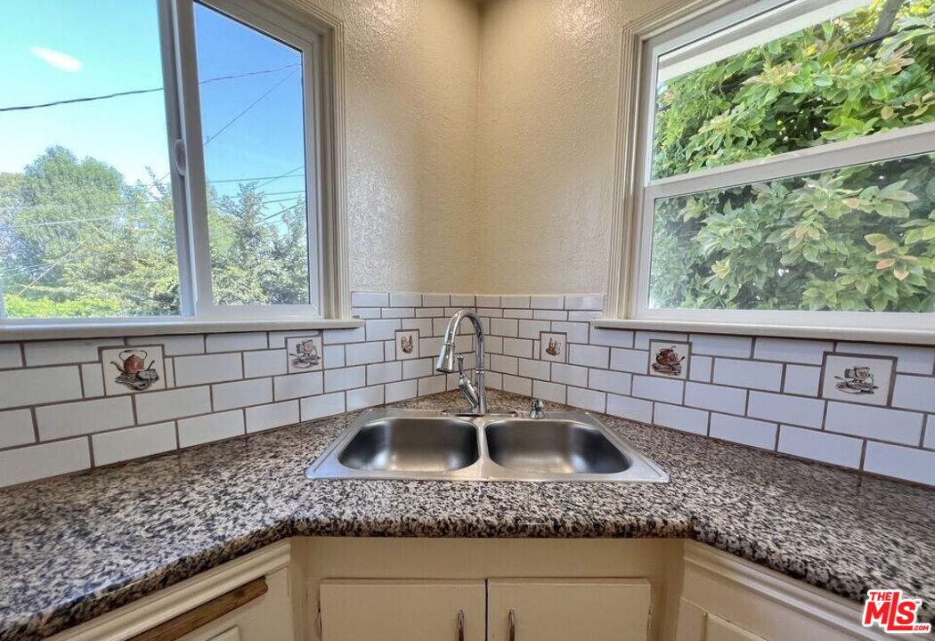 5114 1/2 4th Avenue Los Angeles, CA 90043 - Photo 11 of 23 a kitchen with a sink a granite counter top and a window