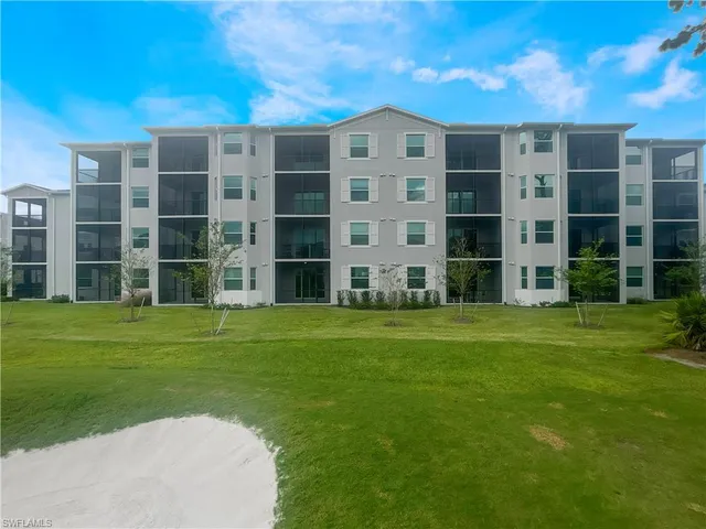 a front view of a building with a garden