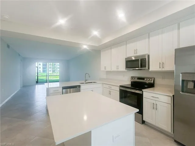 a kitchen with a sink a stove top oven and white kitchen