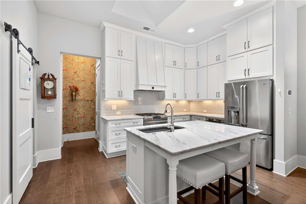 208 Sessions Street Woodstock, GA 30188 - Photo 15 of 47 a kitchen with a stove a refrigerator and a stove top oven