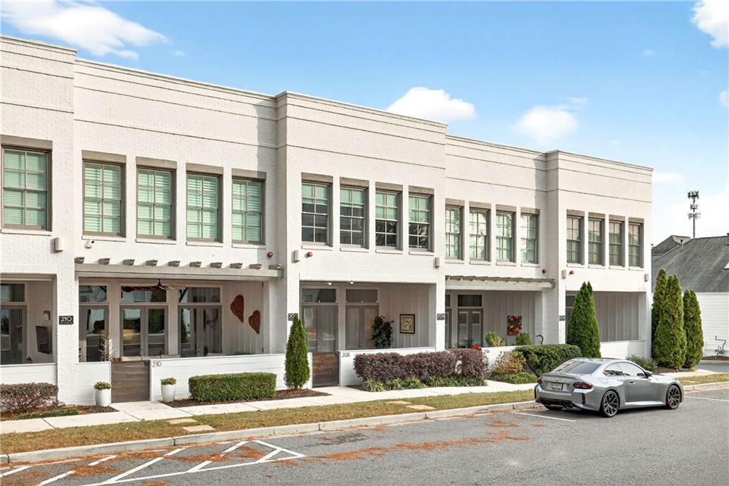 208 Sessions Street Woodstock, GA 30188 - Photo 2 of 47 a building that has a sign on the side of it