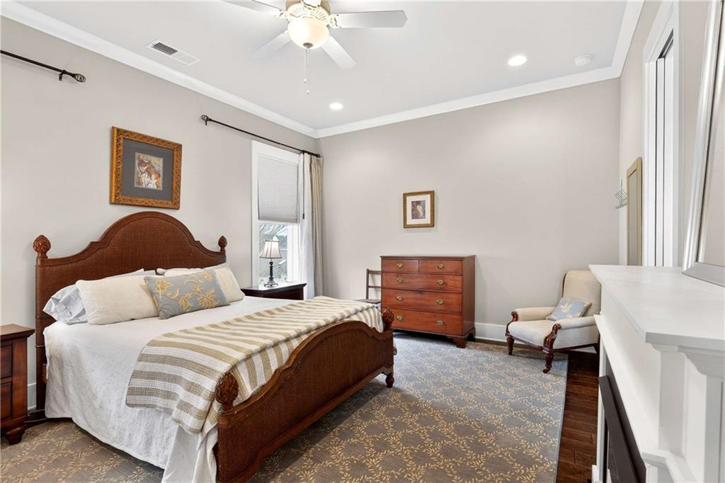 208 Sessions Street Woodstock, GA 30188 - Photo 22 of 47 a bedroom with a bed and wooden floor