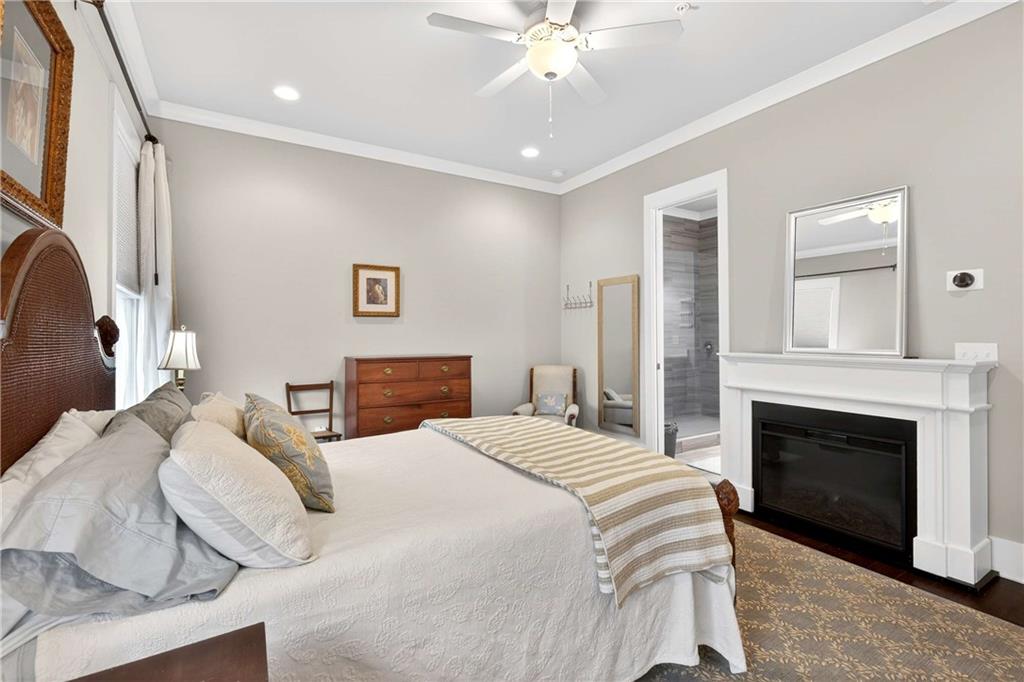 208 Sessions Street Woodstock, GA 30188 - Photo 23 of 47 a spacious bedroom with a bed and a fireplace