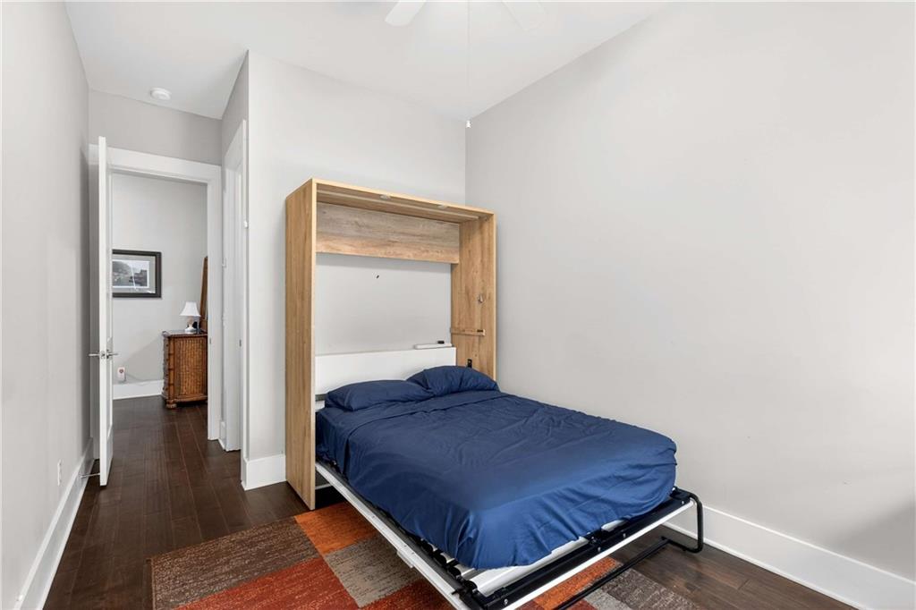 208 Sessions Street Woodstock, GA 30188 - Photo 35 of 47 a bedroom with a bed and wooden floor