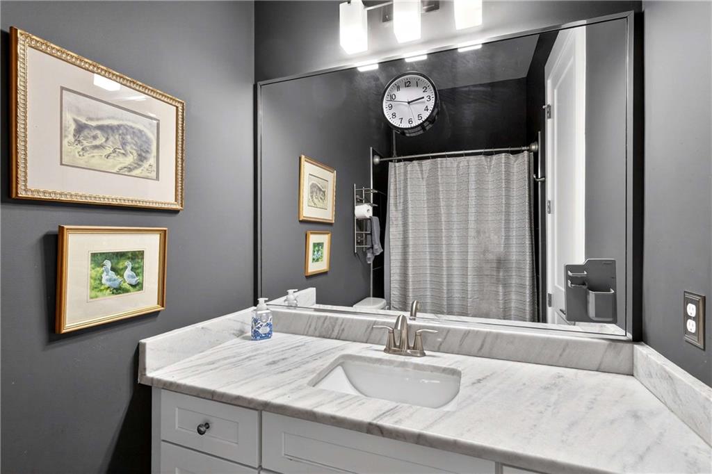208 Sessions Street Woodstock, GA 30188 - Photo 36 of 47 a bathroom with a sink and a mirror