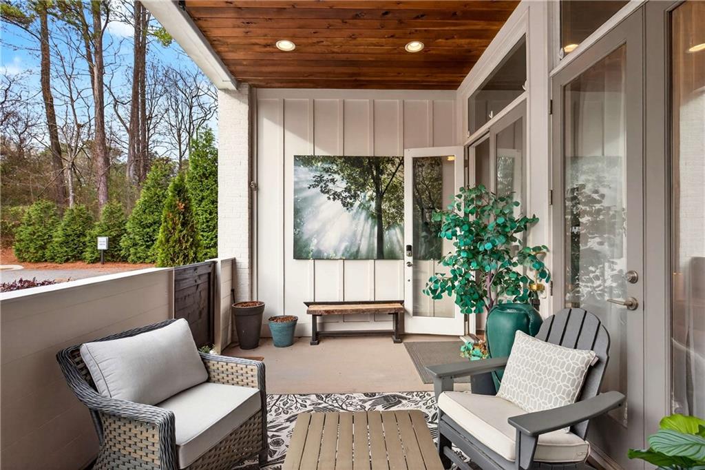 208 Sessions Street Woodstock, GA 30188 - Photo 4 of 47 a balcony with furniture and a potted plant