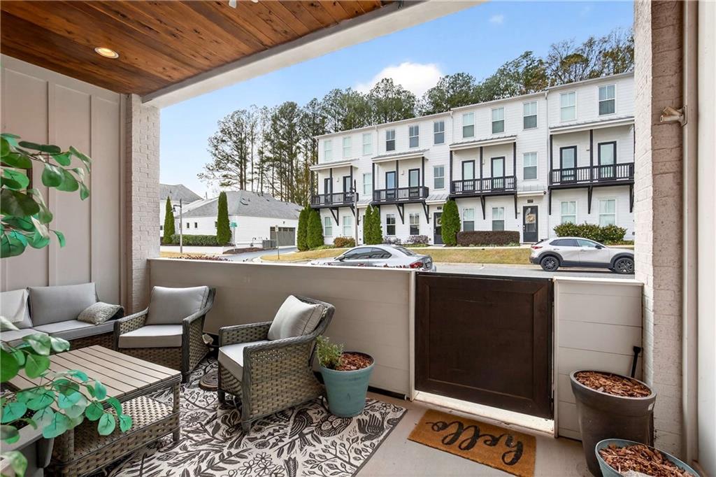 208 Sessions Street Woodstock, GA 30188 - Photo 5 of 47 a outdoor living space with furniture and a potted plant