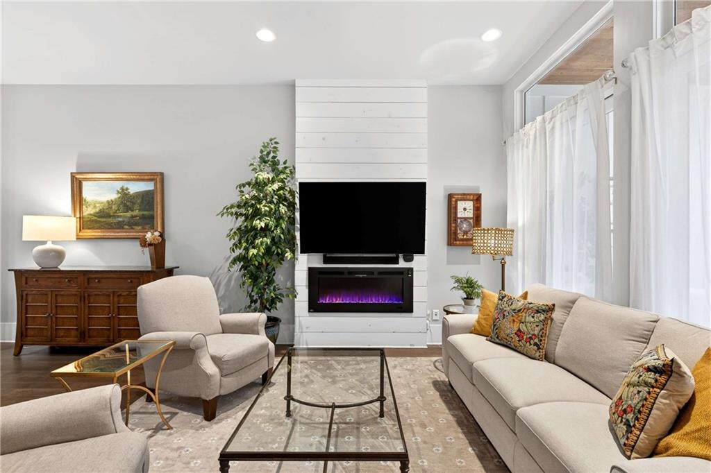 208 Sessions Street Woodstock, GA 30188 - Photo 10 of 47 a living room with furniture and a flat screen tv