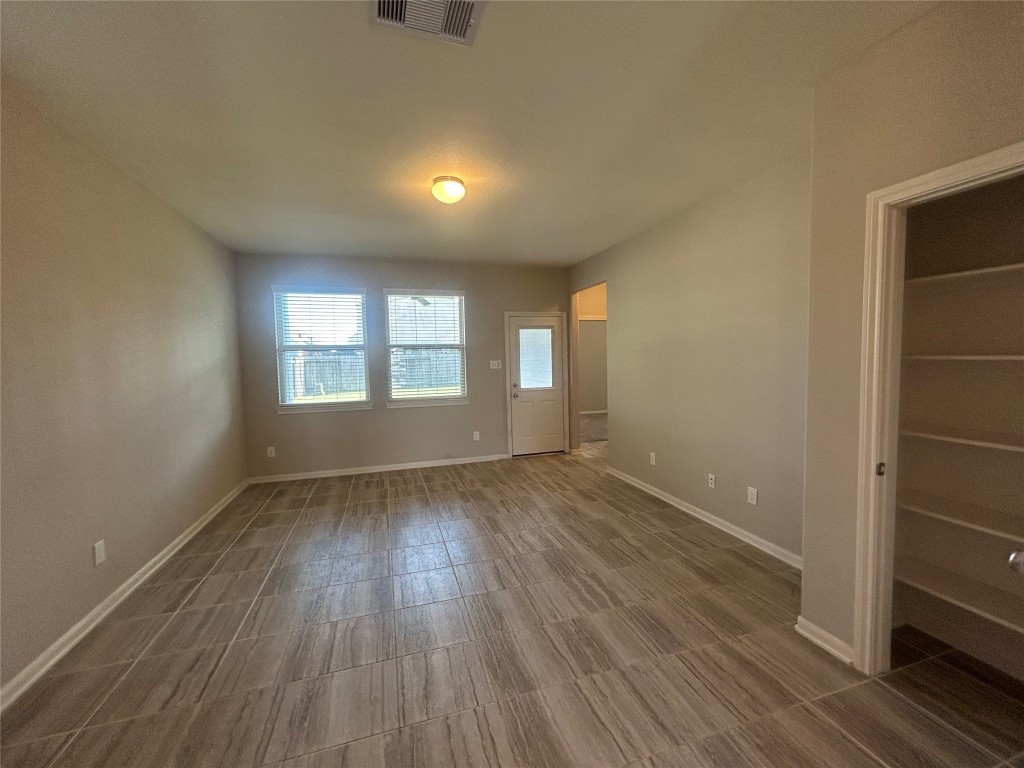 3132 Dunsmore Manor Court Spring, TX 77386 - Photo 11 of 18 an empty room with wooden floor and windows