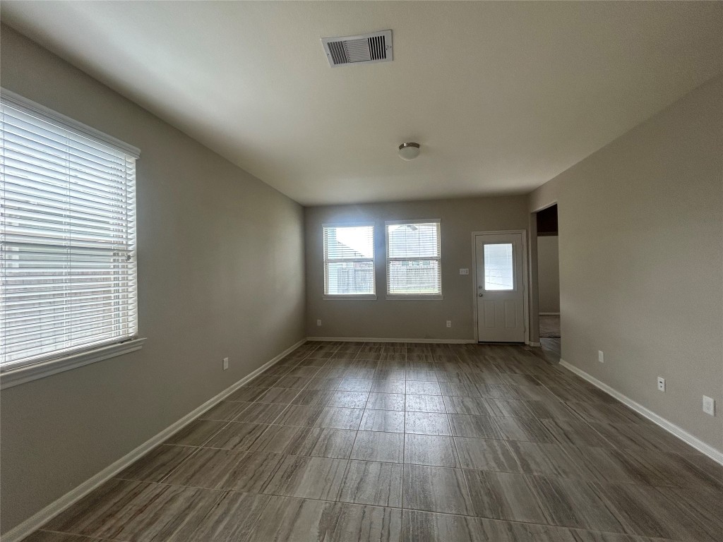 3132 Dunsmore Manor Court Spring, TX 77386 - Photo 17 of 18 a view of an empty room with wooden floor and window