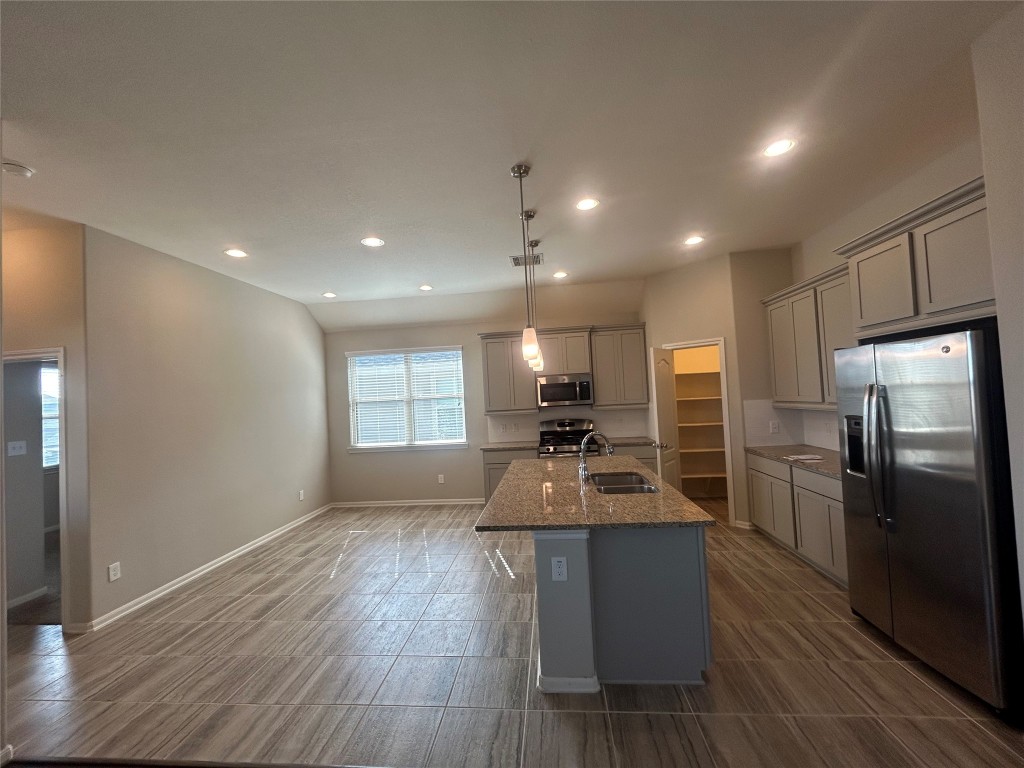 3132 Dunsmore Manor Court Spring, TX 77386 - Photo 5 of 18 a kitchen with sink refrigerator and microwave