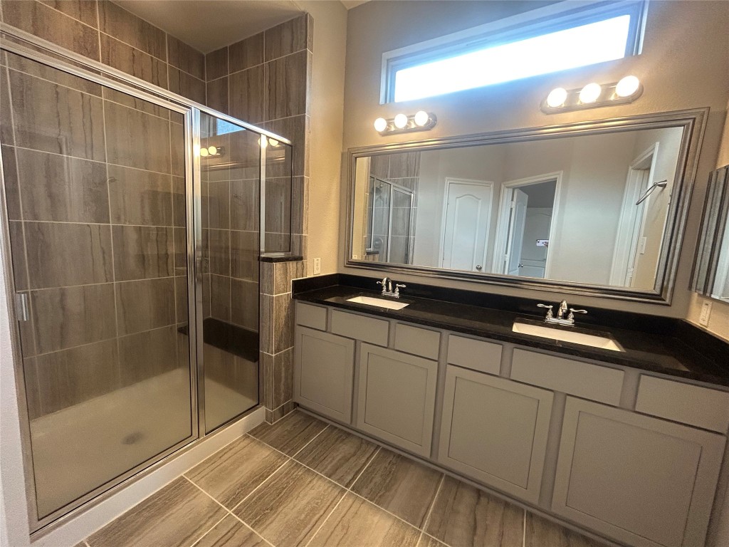3132 Dunsmore Manor Court Spring, TX 77386 - Photo 10 of 18 a bathroom with a double vanity sink and mirror
