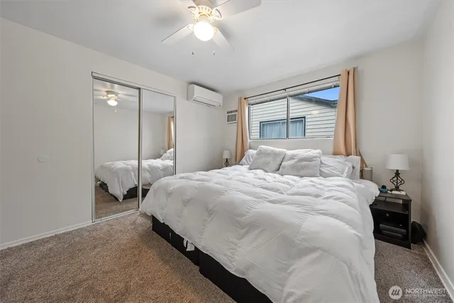 a bedroom with a large bed and a chandelier