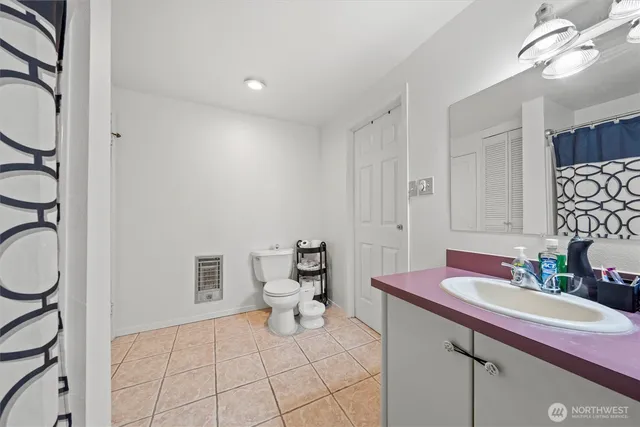 a bathroom with a sink toilet and a mirror