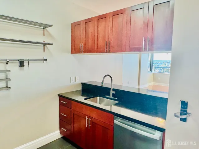 a view of a kitchen with wooden floor and a ceiling fan