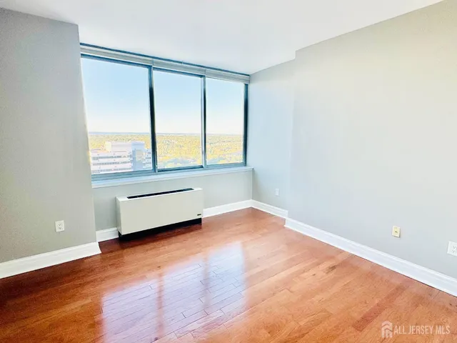 a view of a room with wooden floor and bench