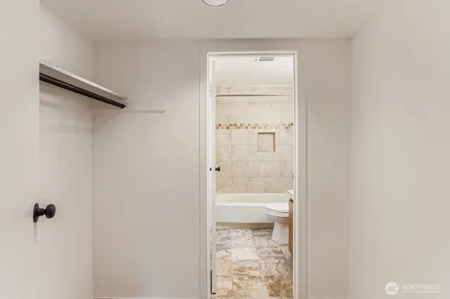 a bathroom with a glass shower door