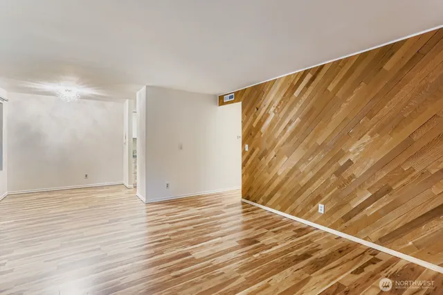 a view of an empty room with wooden floor