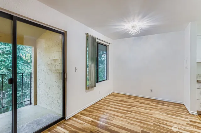 a view of a room with wooden floor and windows