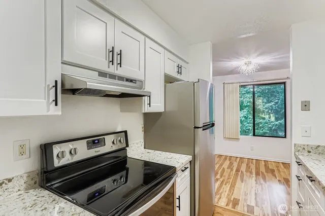 a kitchen with wooden cabinets and a stove top oven