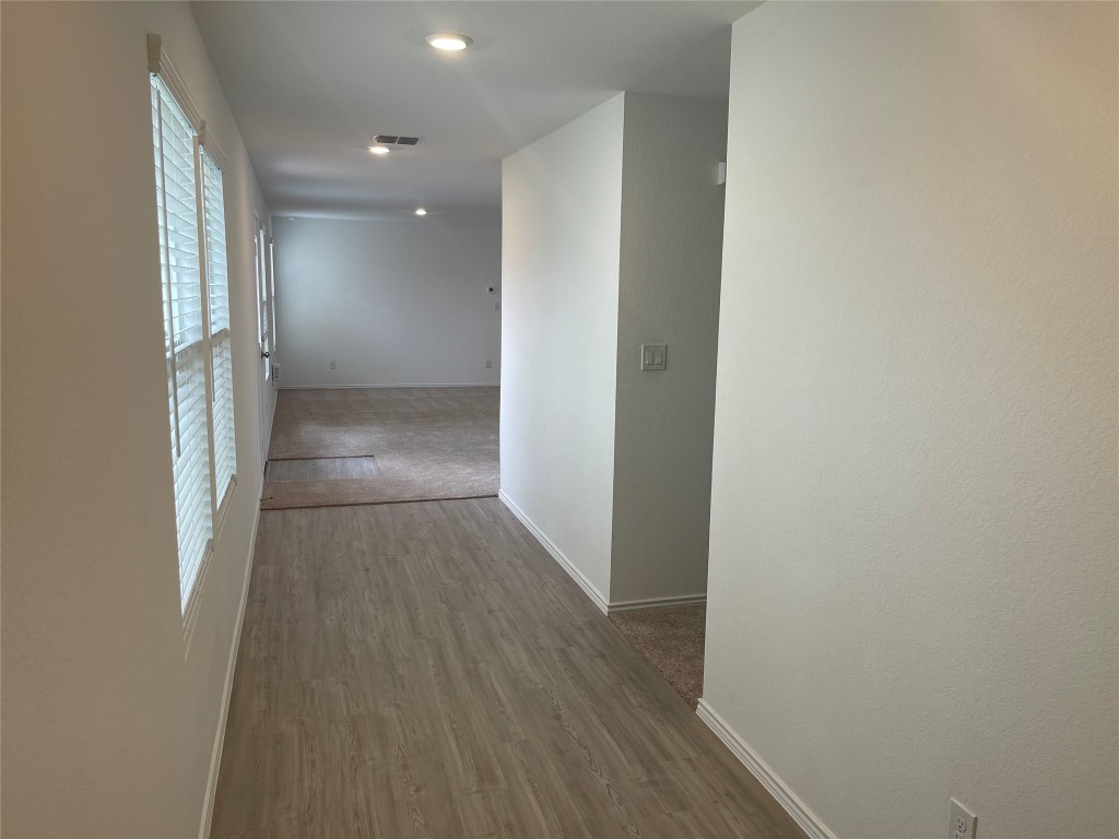 576 Avre Loop Kyle, TX 78640 - Photo 2 of 11 a view of hallway with wooden floor