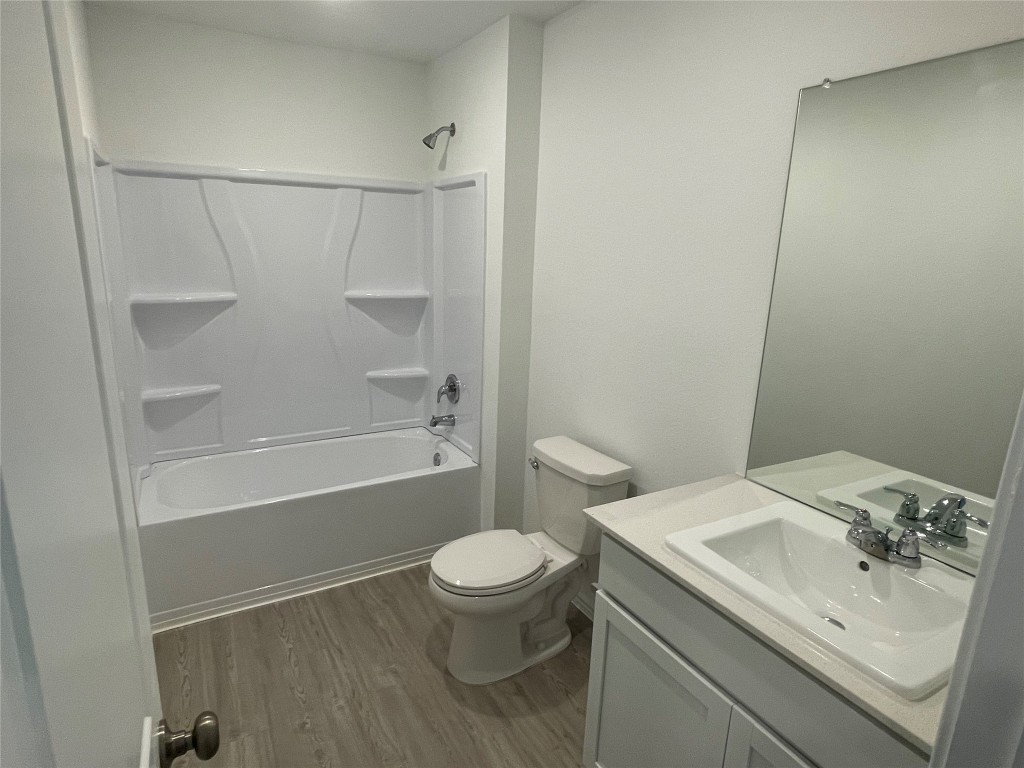 576 Avre Loop Kyle, TX 78640 - Photo 4 of 11 a bathroom with a sink a toilet and shower
