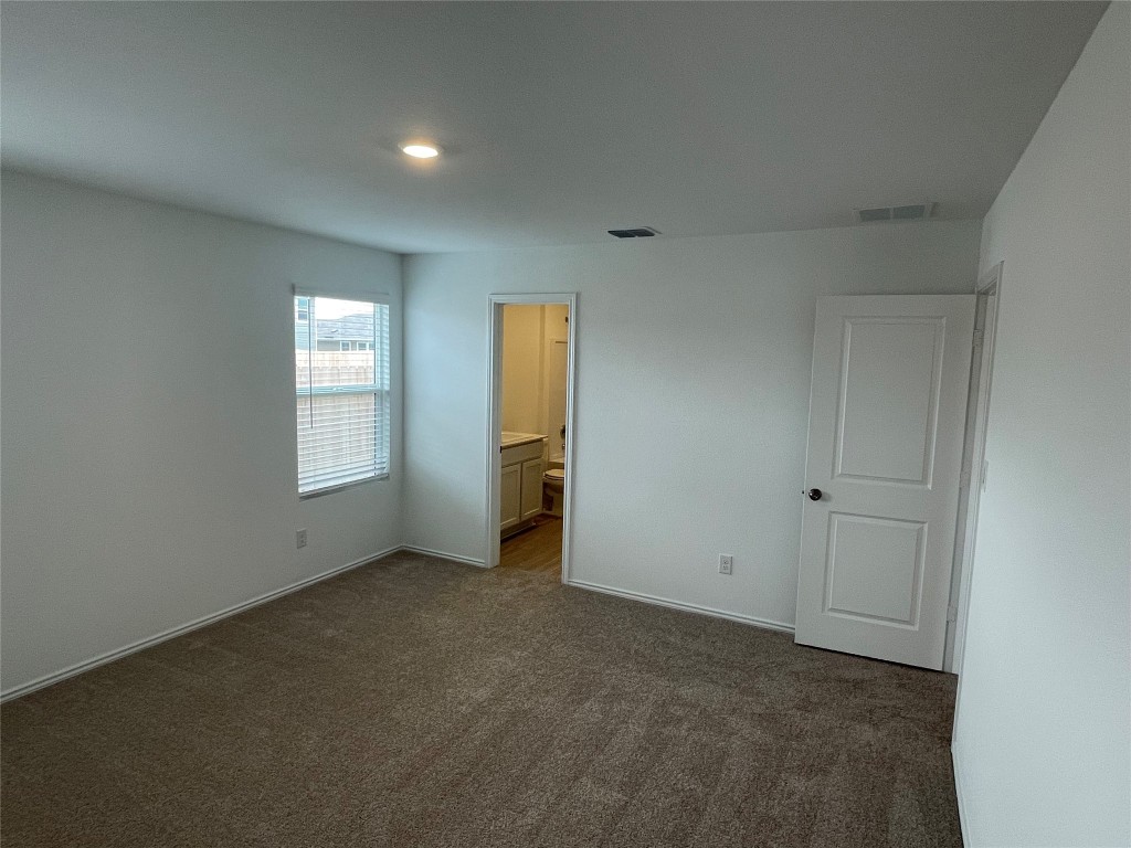 576 Avre Loop Kyle, TX 78640 - Photo 9 of 11 an empty room with windows and closet