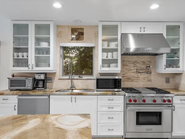 a living room with furniture and kitchen view