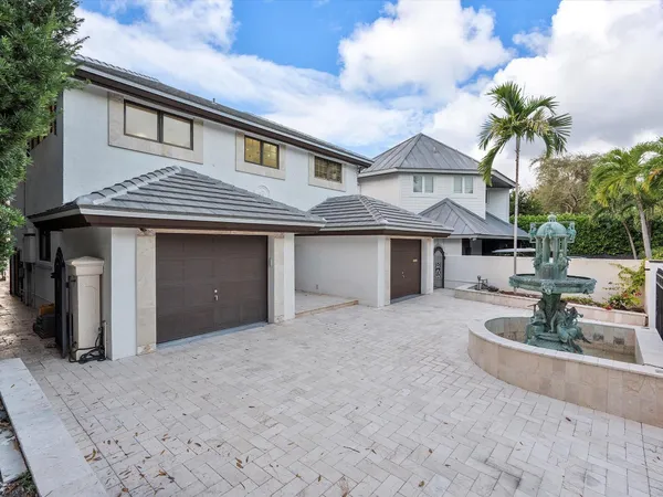 a living room with furniture a dining table and kitchen view with wooden floor